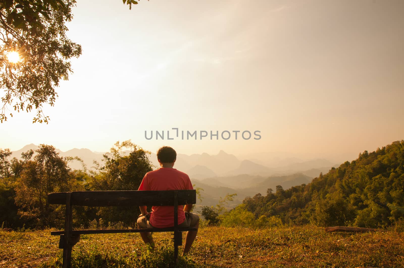 Young man looked sunset by Sorapop