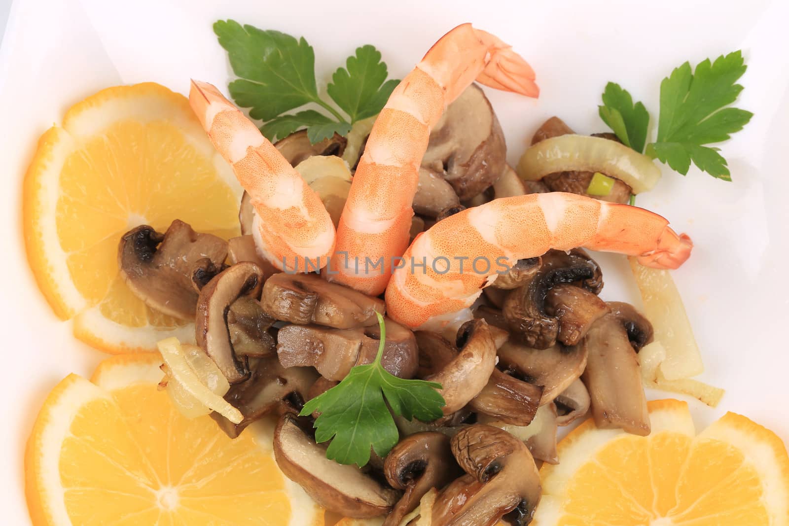 Shrimp salad with mushrooms and lemons. Isolated on a white background.