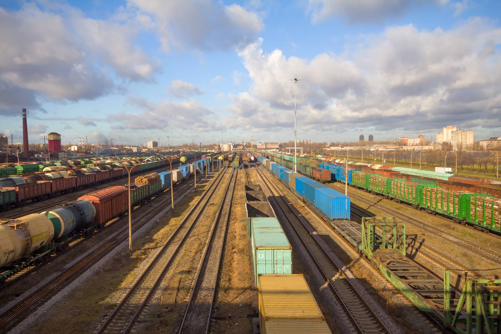 Freight train with color cargo containers passing railway station