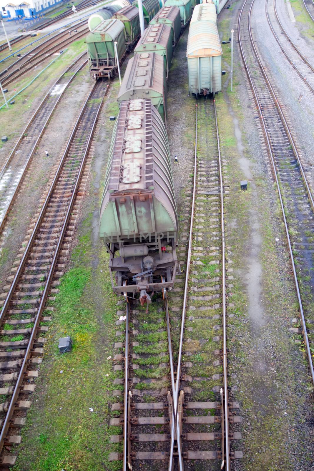 Freight train with color cargo containers passing railway station