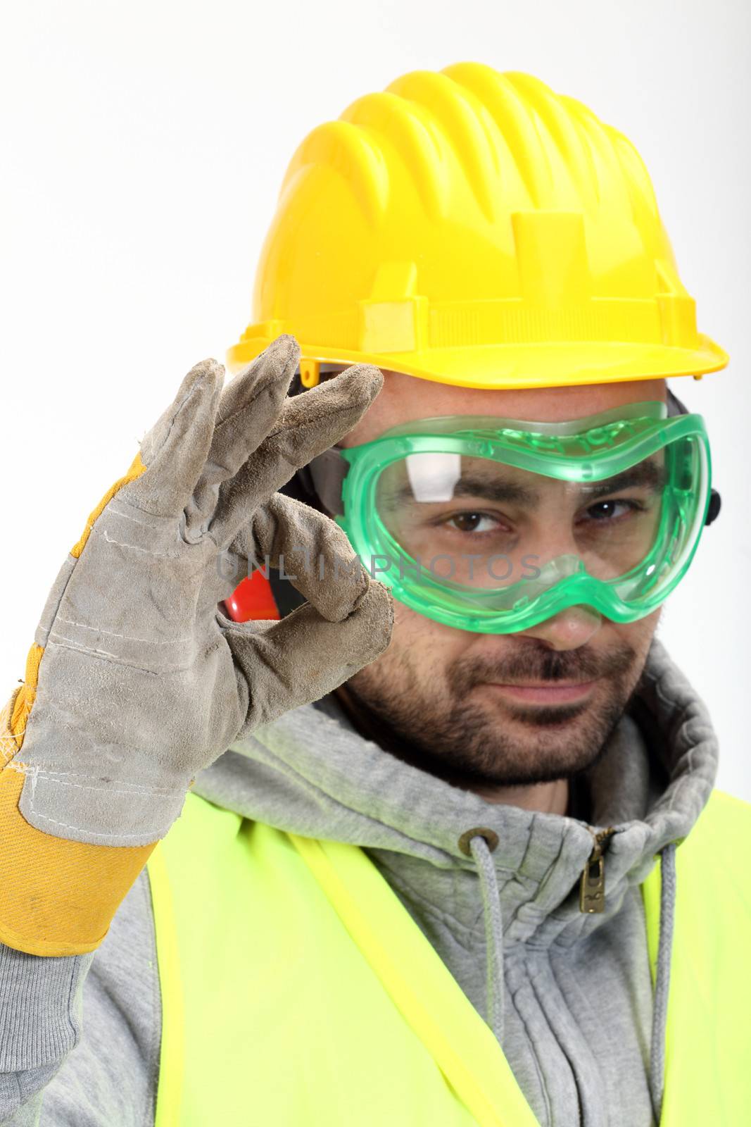 Worker with protective gear showing OK sign