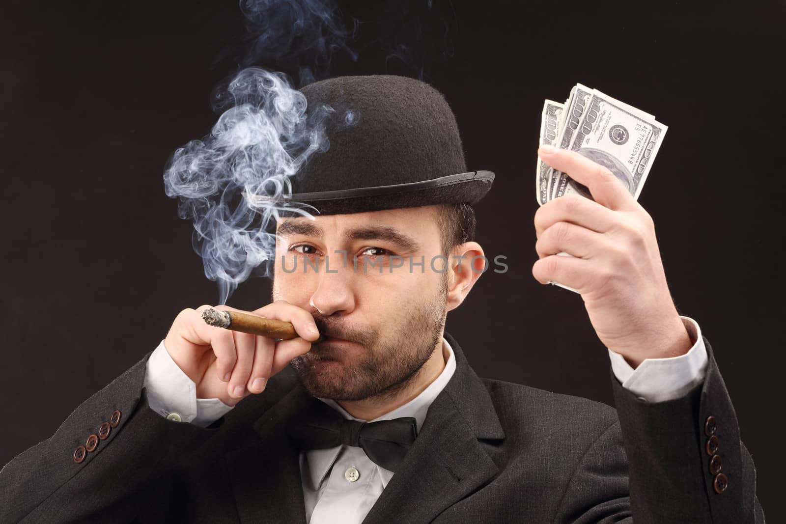 Portrait of man in suit with dollar bills 