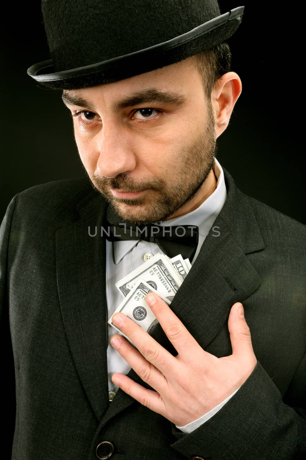 Portrait of man in suit with dollar bills