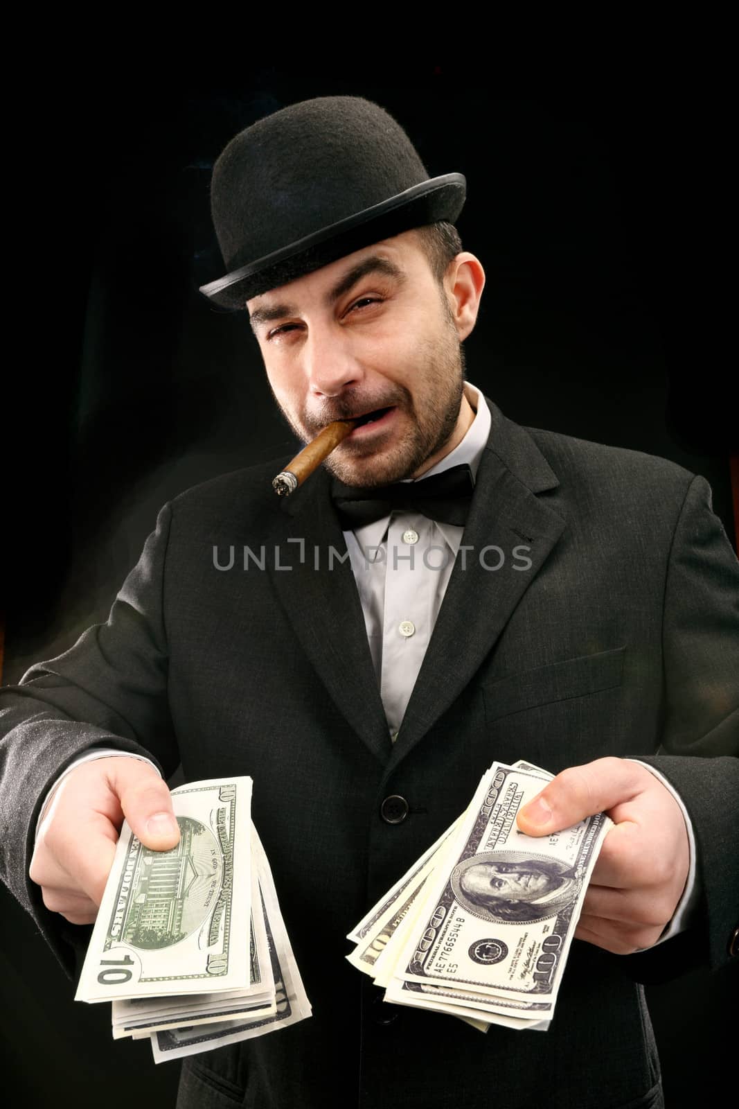 Portrait of man in suit with dollar bills 