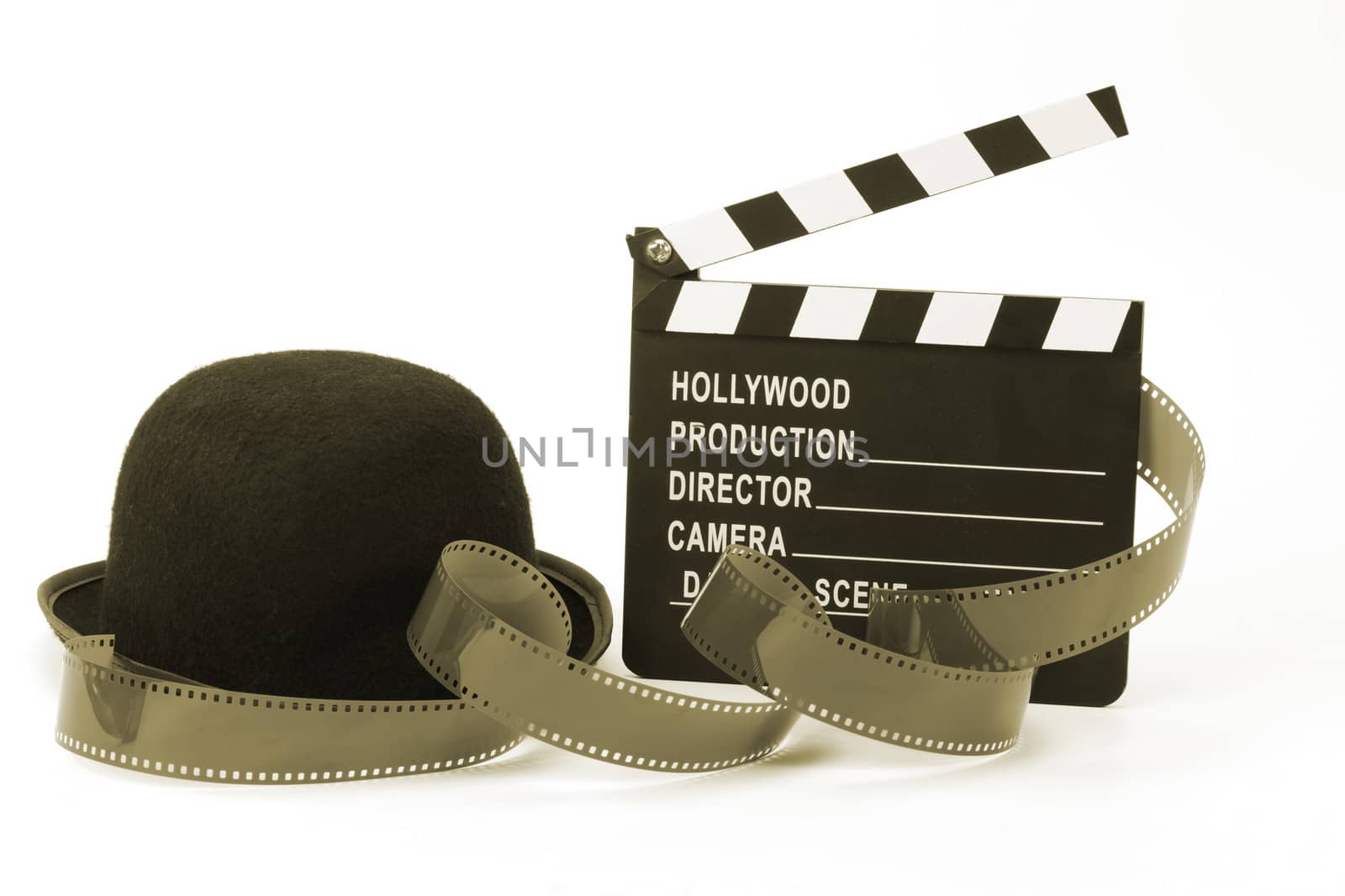 Bowler hat and movie clapper over white . Black and white picture