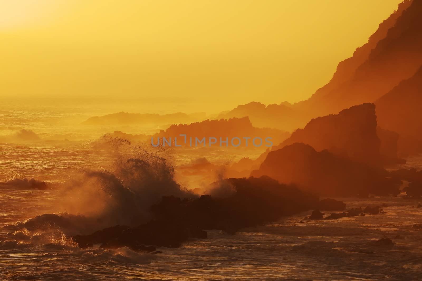 Silhouette outline of the rugged coastline in South Africa at sunset