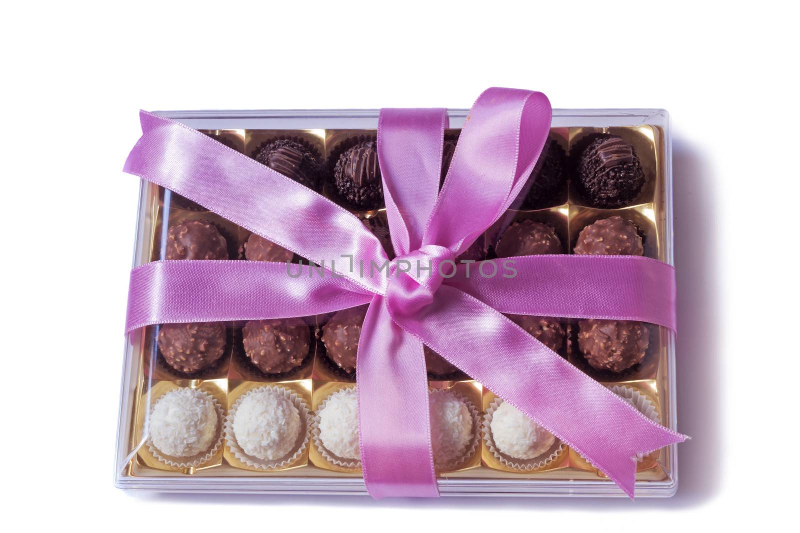 Box of delicious chocolates, nicely decorated and tied with a ribbon gift for any holiday or celebration. Presented on a white background