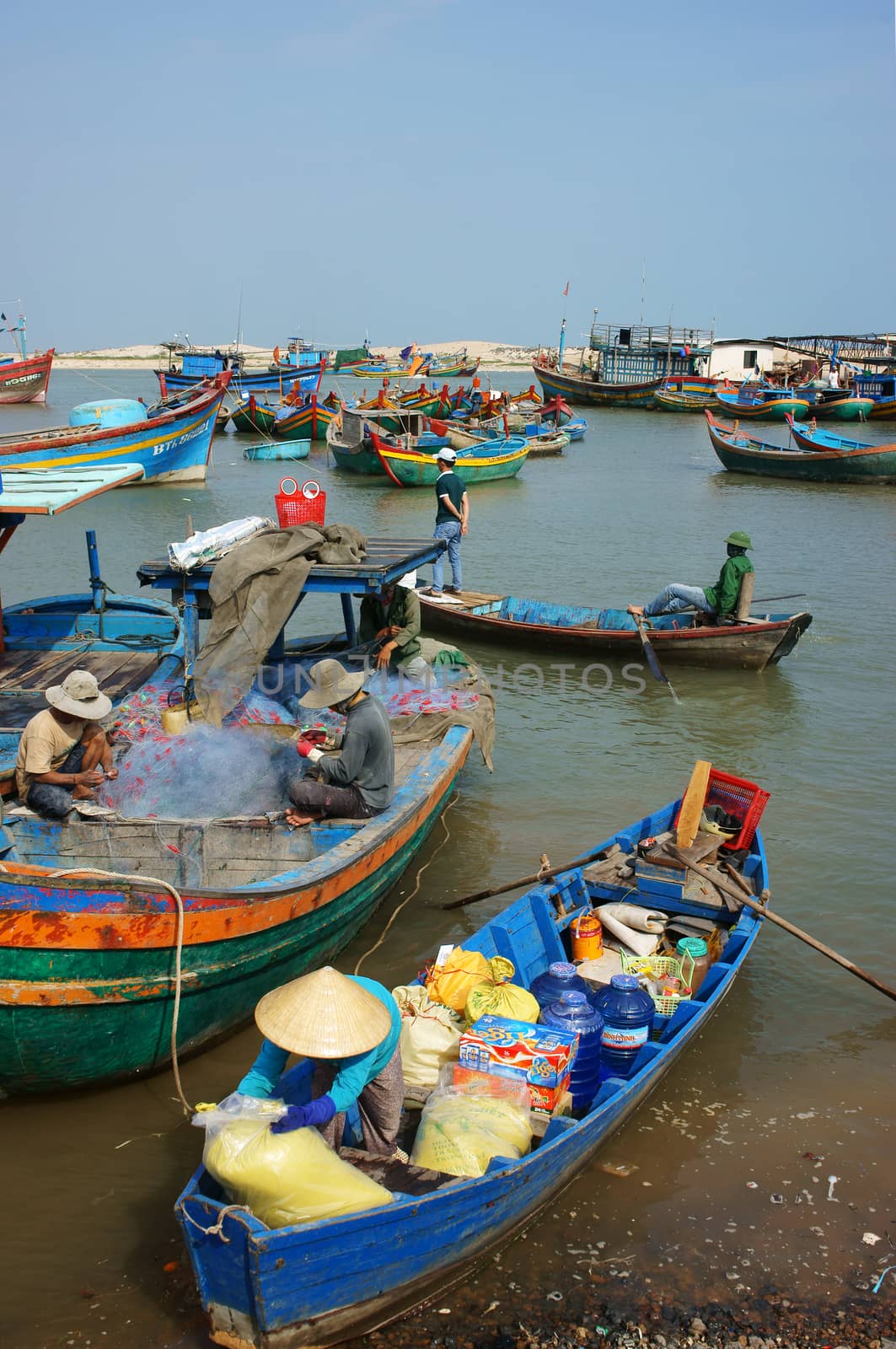 Transportation people and goods by wooden boat at habor by xuanhuongho