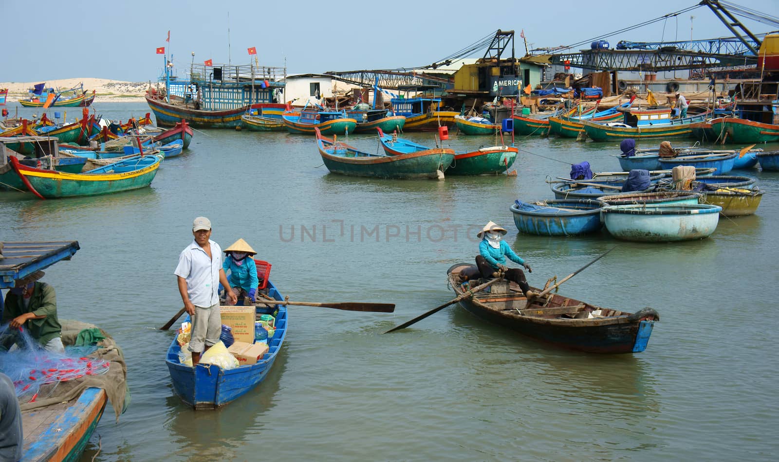 Transportation people and goods by wooden boat at habor by xuanhuongho