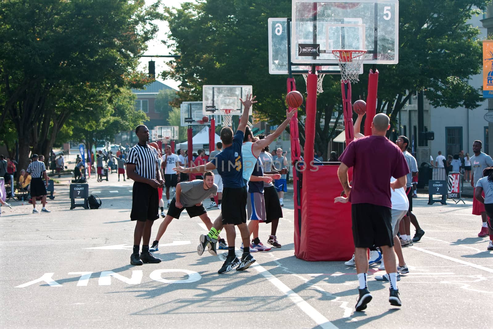 Athens, GA, USA - August 24, 2013:  A man shoots a layup in a 3-on-3 basketball tournament held on the streets of downtown Athens.