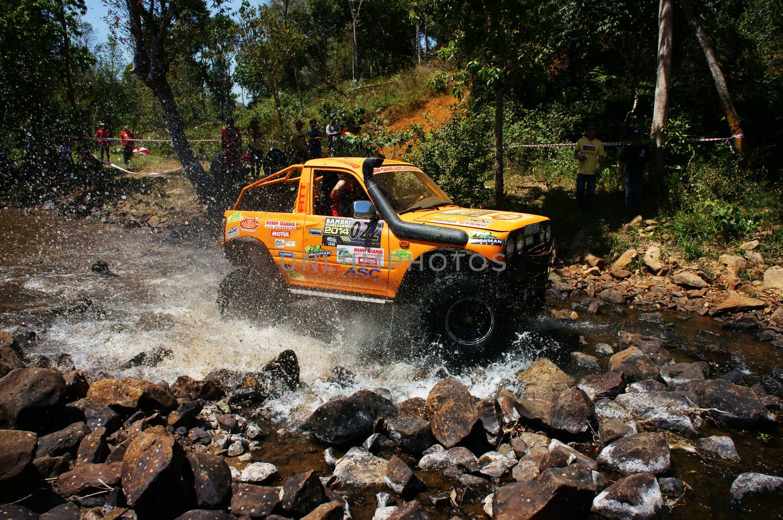 BAO LOC, VIETNAM- FEB 24: Racer at terrain racing car competition,motor cross stream that extreme off road with rock on water, competitor  adventure in championship spirit, Viet Nam, Feb 24, 2014