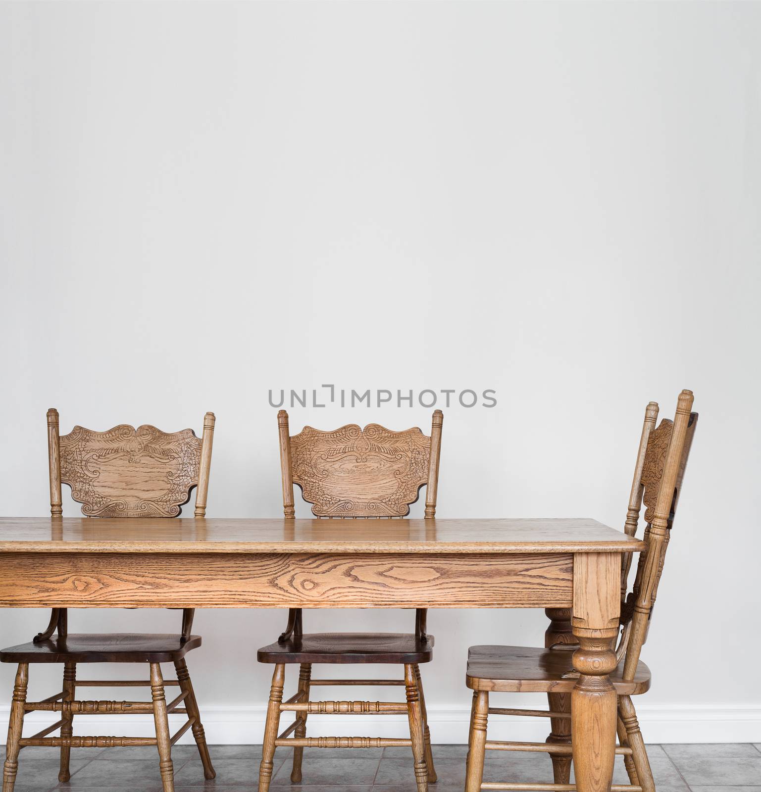 Wooden Dining room table and chair details and blank wall for your text, image or logo.