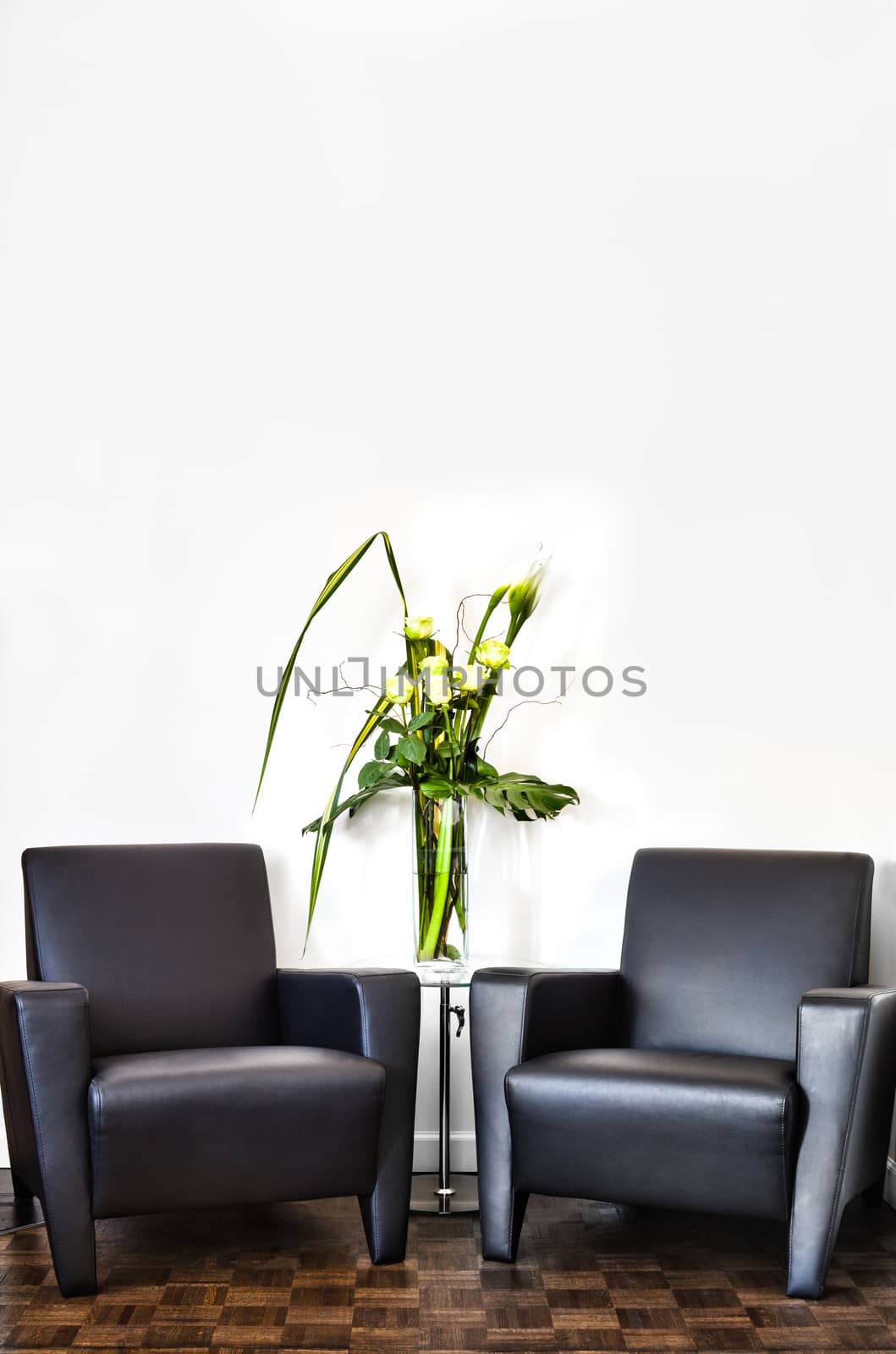 Modern Interior Room and white wall with space for your text. Two luxurious couch and glass table with accessories of your choice.