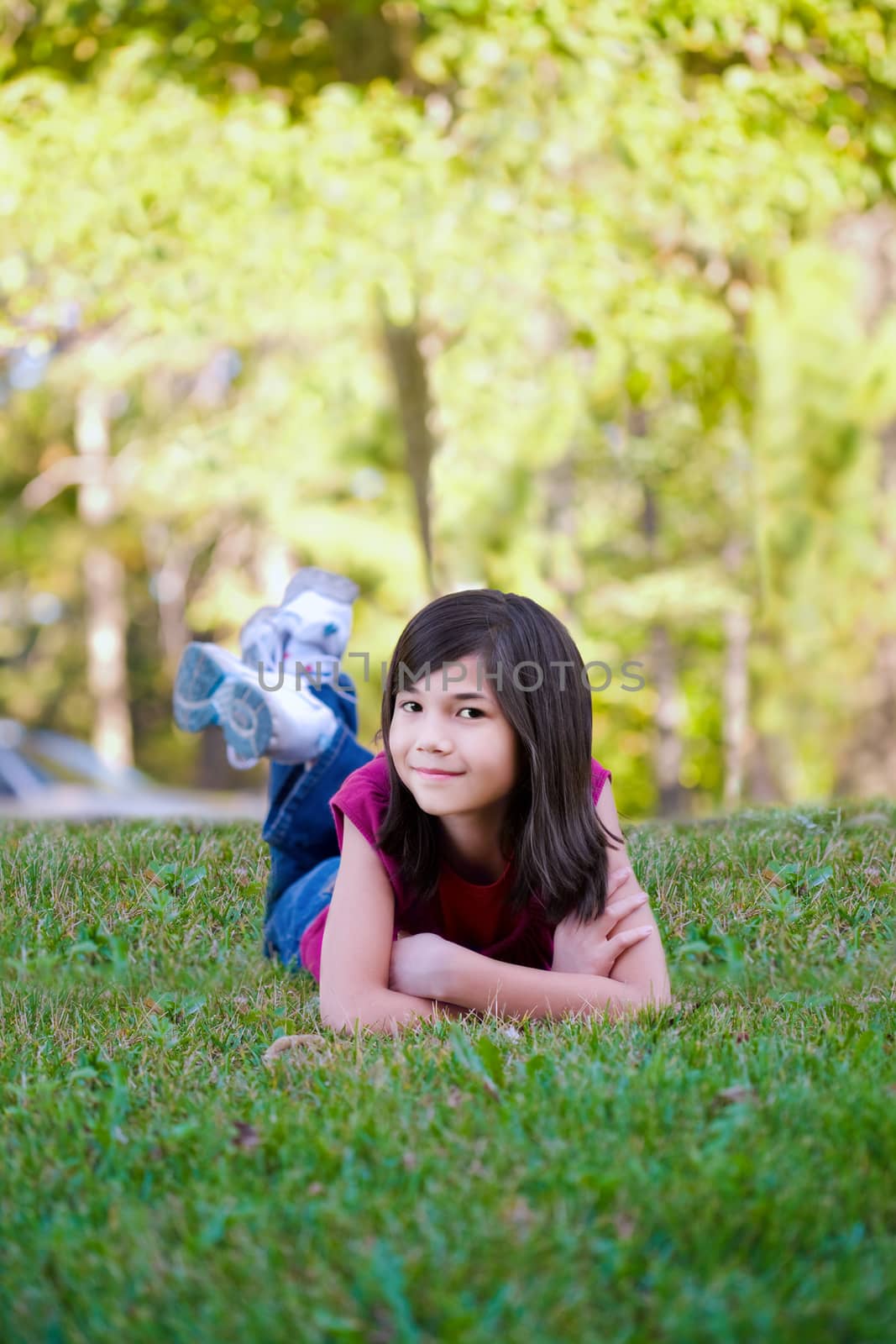 Little girl lying down on grass by jarenwicklund