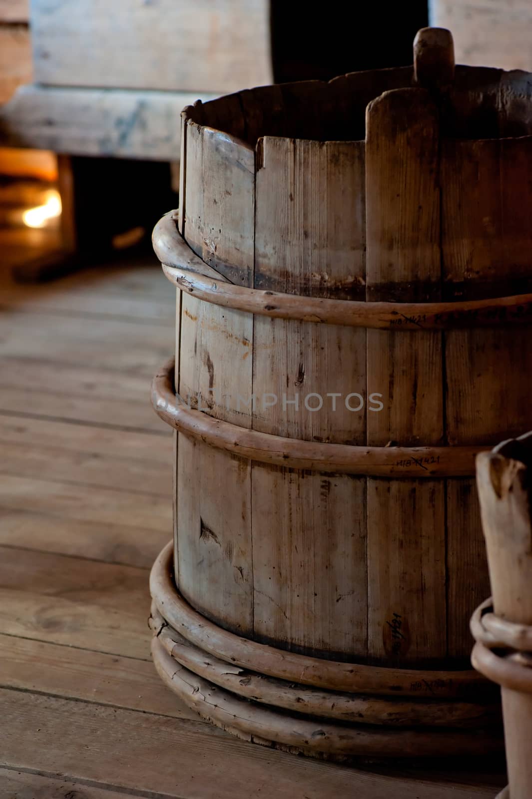 Old wooden bucket close-up in house by kosmsos111