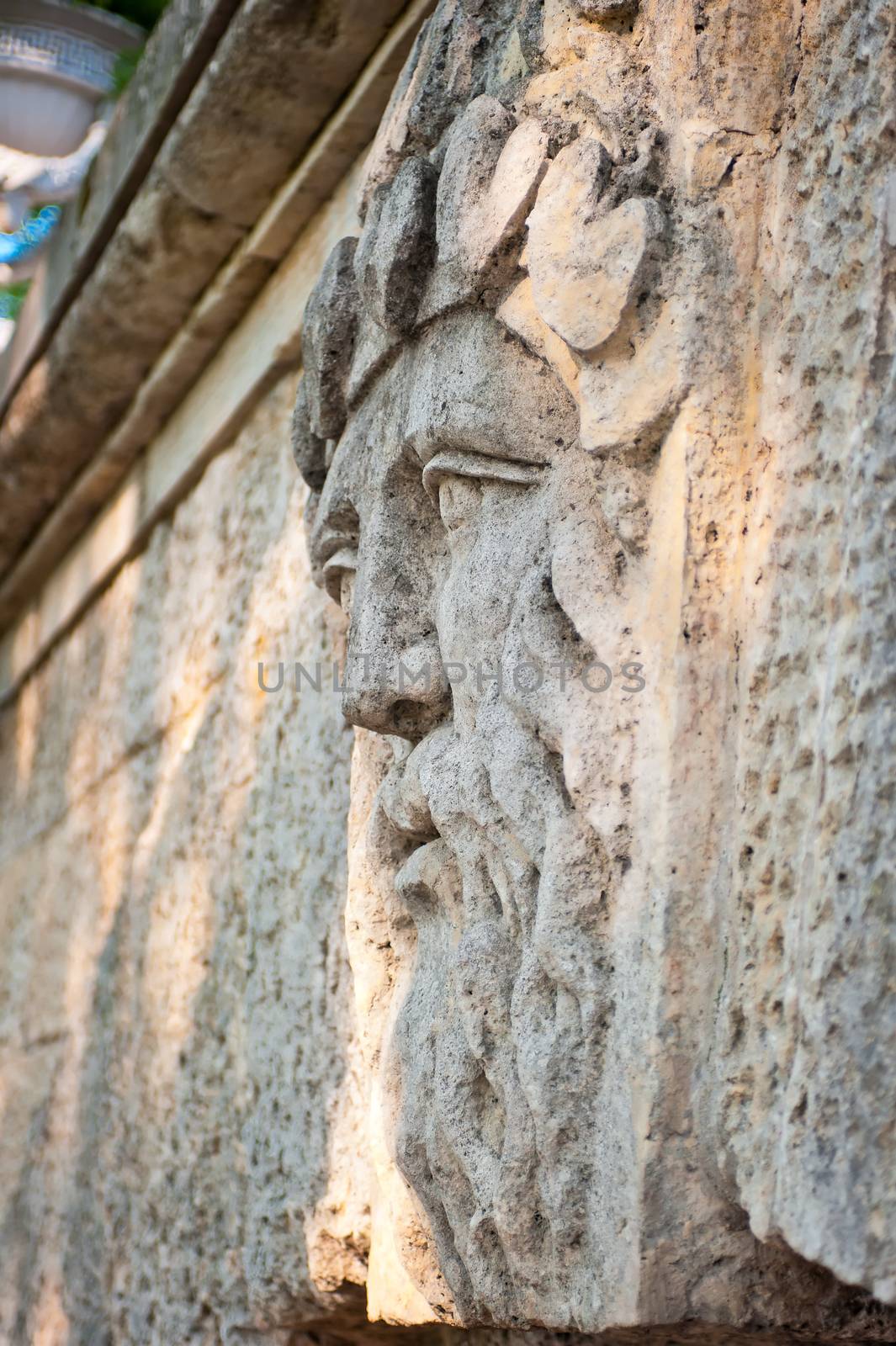 face of a man with a beard carved in stone
