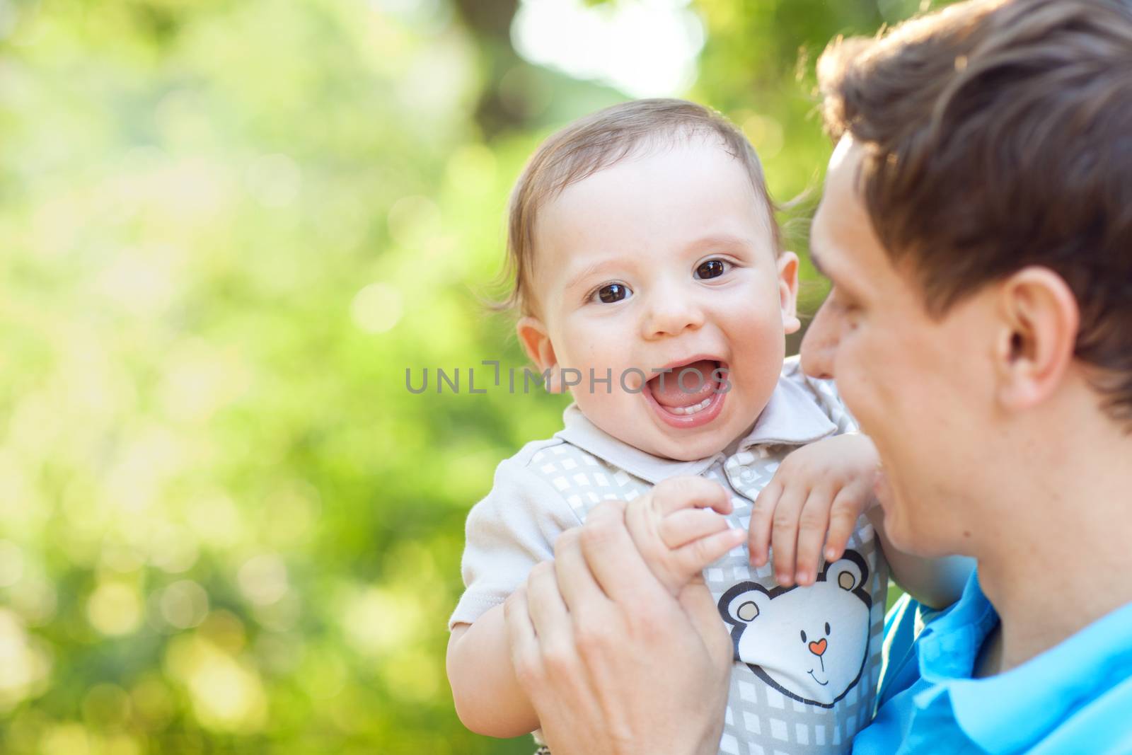 laughing boy in fathers hands by vsurkov