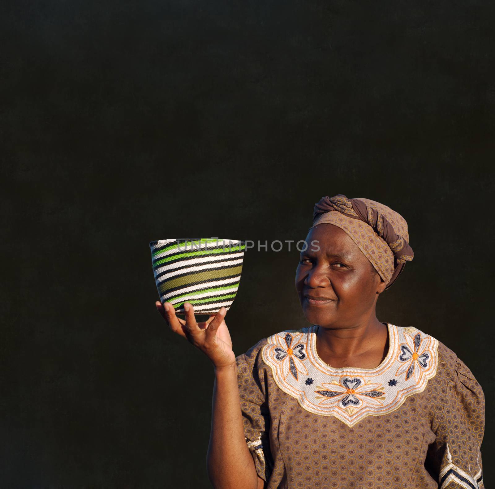 Traditional South African Zulu woman basket sales woman on blackboard background by alistaircotton