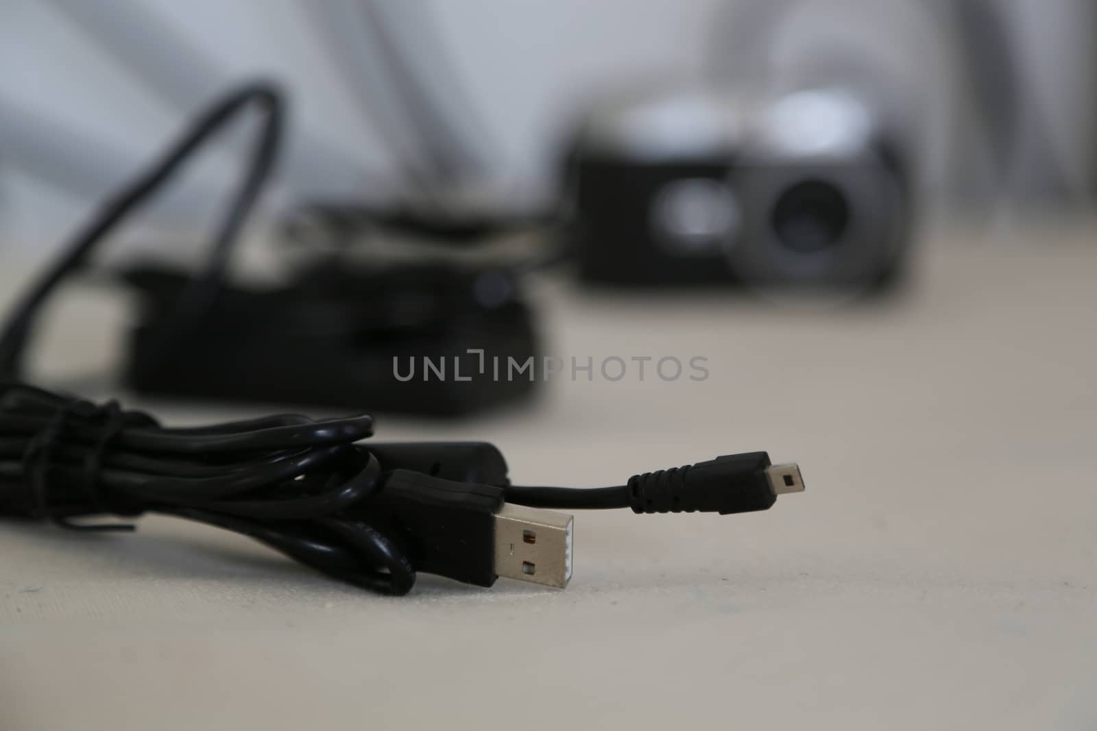 black interface cable with digital camera in the background