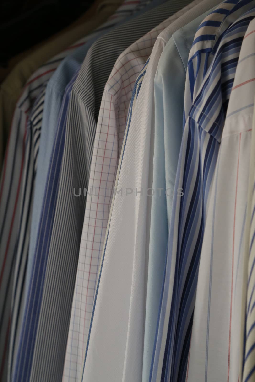 row ofbusiness man's hanging shirts of different colors