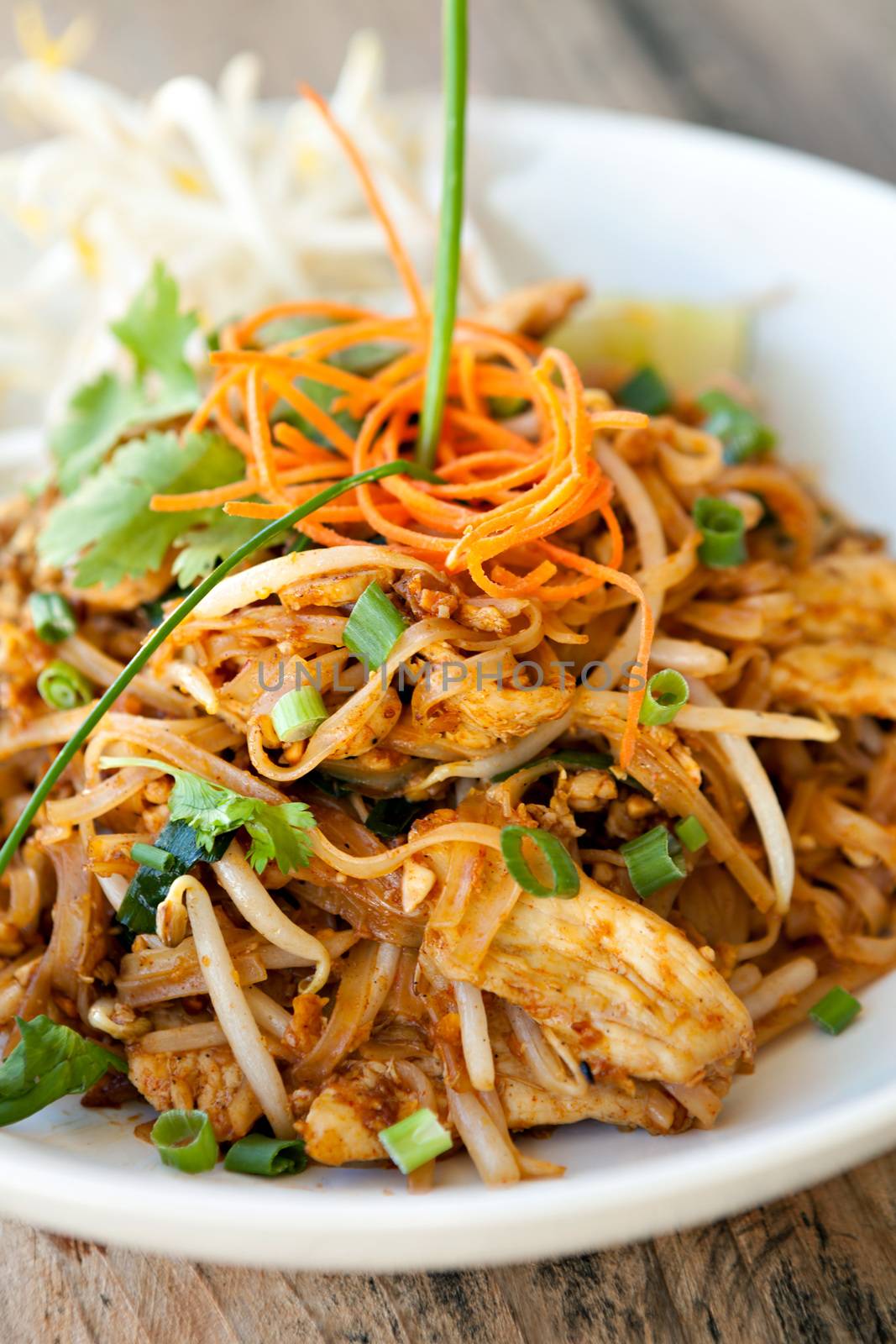 Chicken pad Thai dish of stir fried rice noodles with a contemporary presentation.