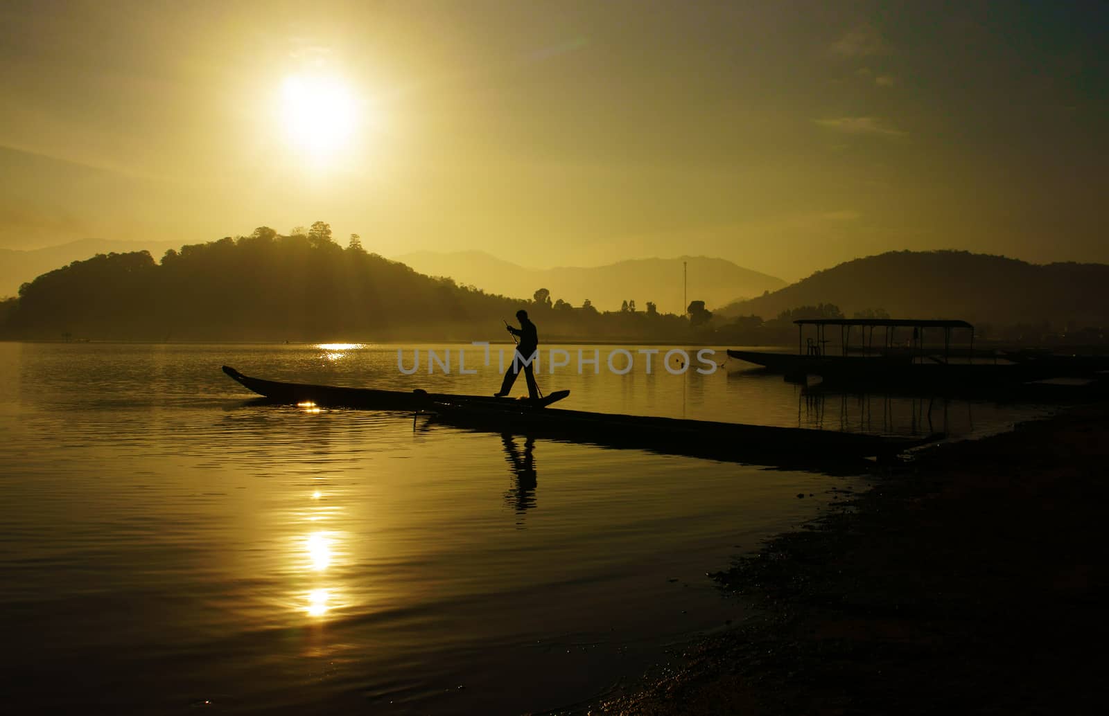 Beautiful landscape with sunset on lake, image of sun and people reflect on surface water                   