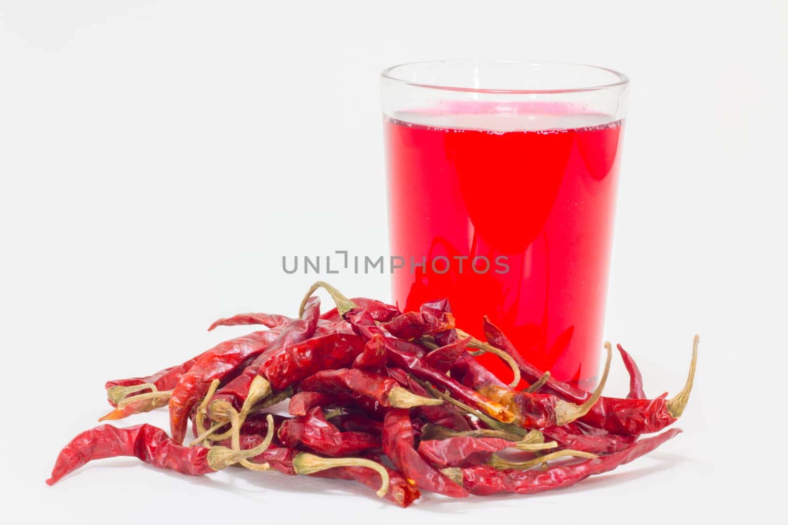 full dried chilli pepper juice on white background good for health
