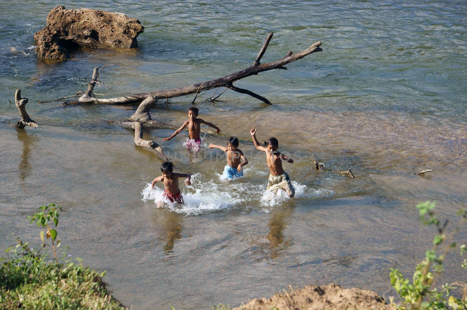 KHANH HOA, VIET NAM- FEBRUARY 5: Chidren playing, bathe in the river, this is warning about  children's drowning  situation at countryside, Khanh Hoa, February 5, 2013