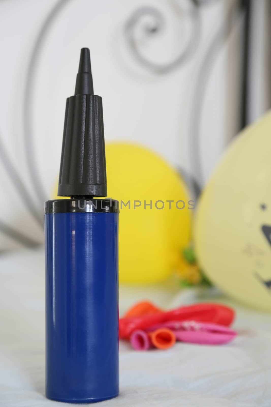 dark blue hand-held balloon inflator by tolikoff_photography