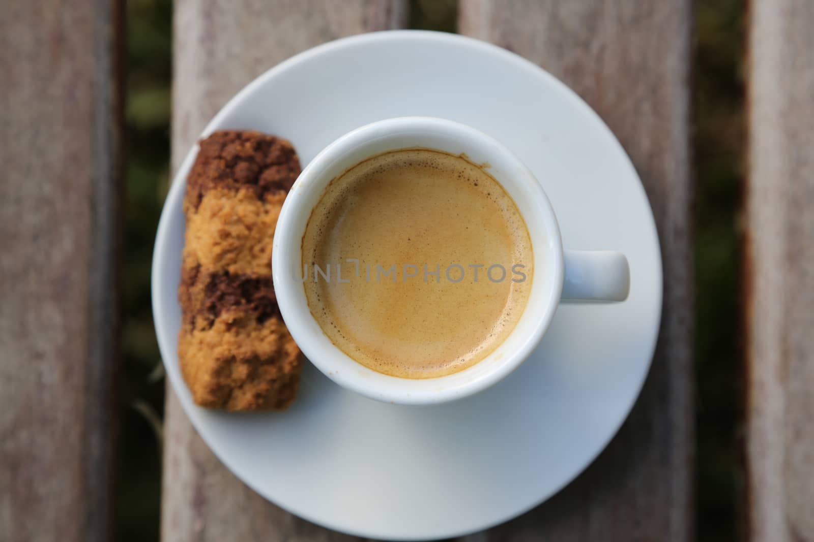 A cup of Italian espresso with a biscuit by tolikoff_photography