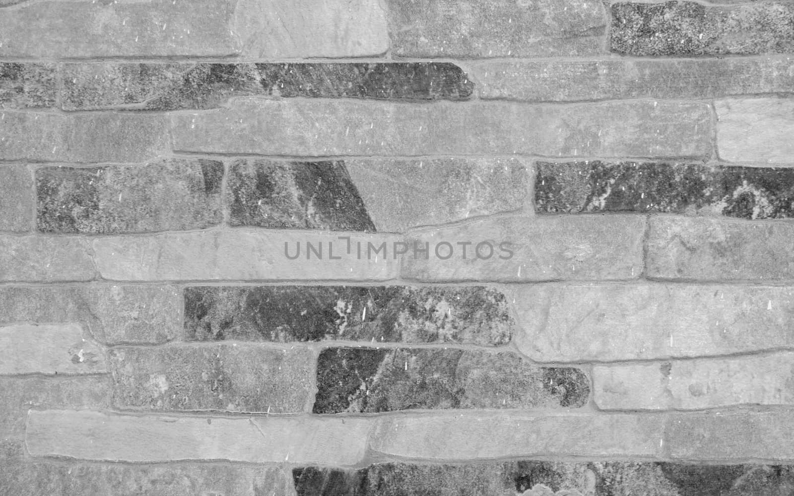 Faced wall with decorative capstone in black and white - background