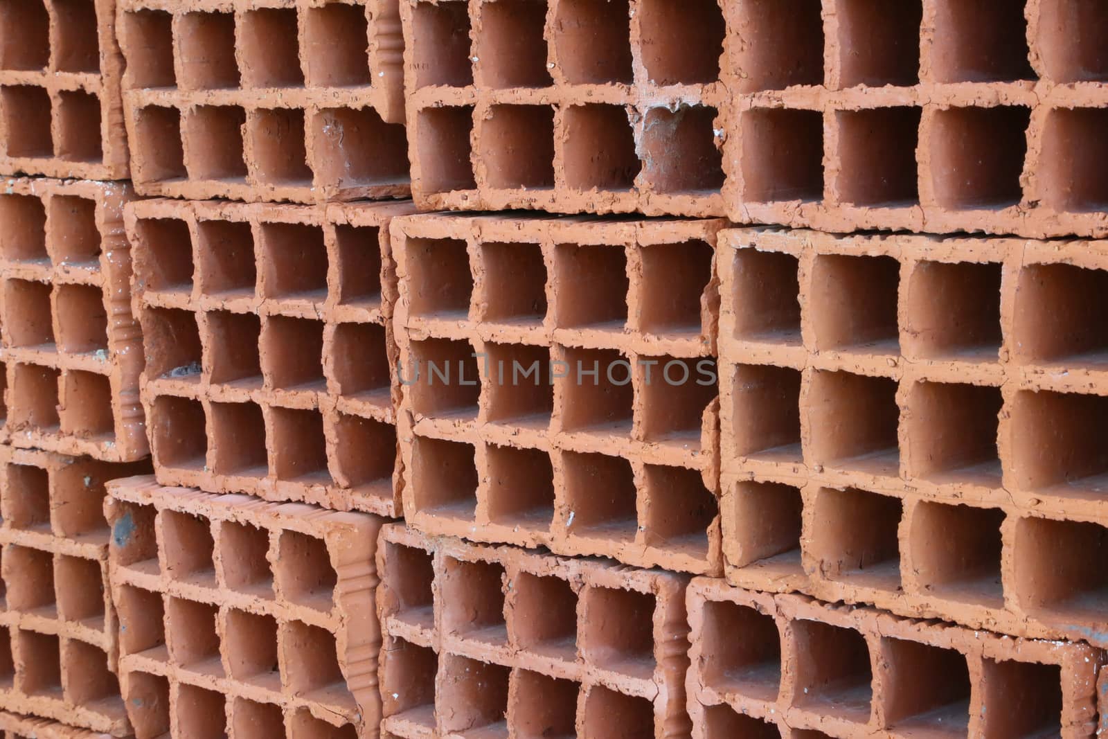 A row of hollow red clay bricks - background