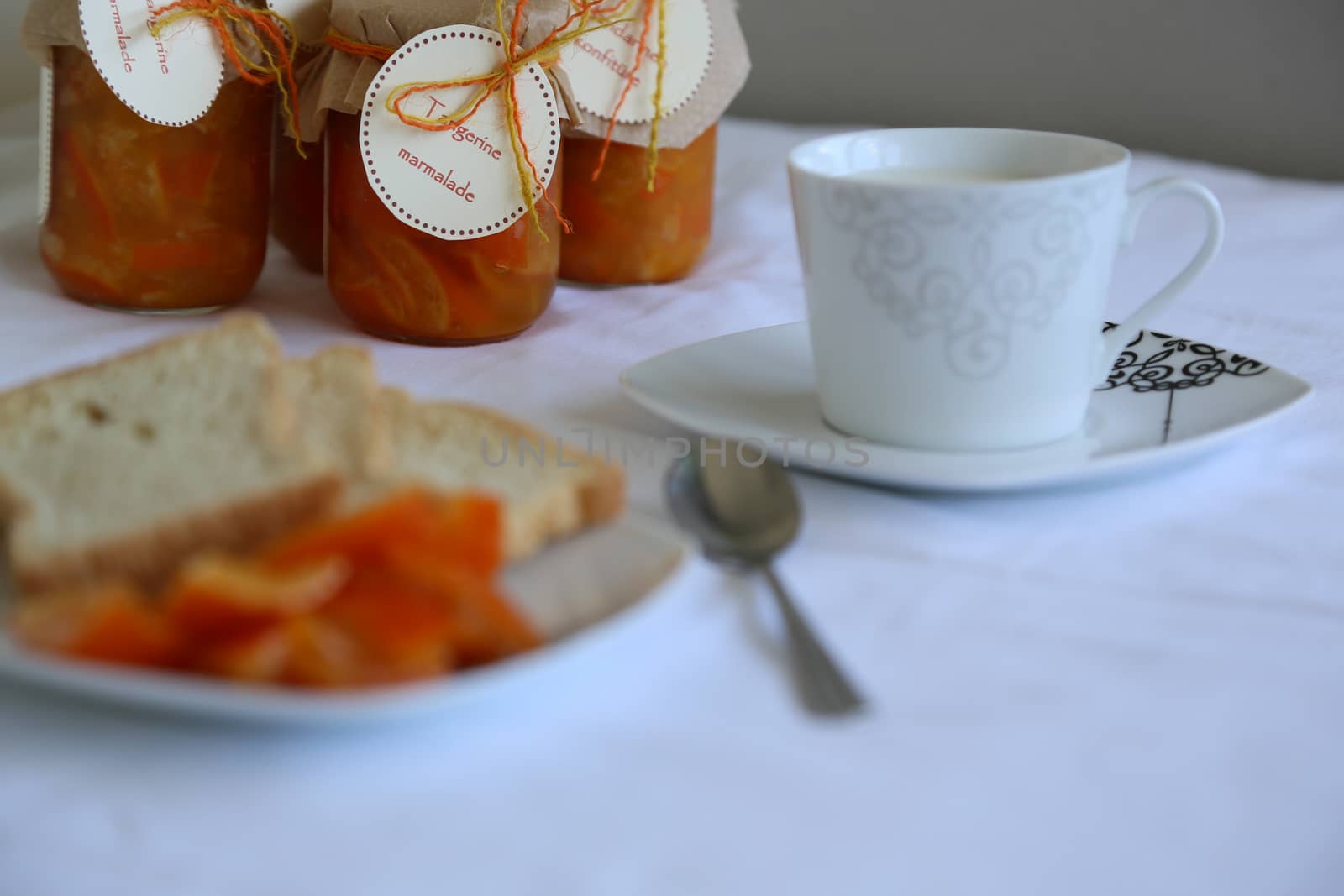 Homemade tangerine marmalade and a cup of milk