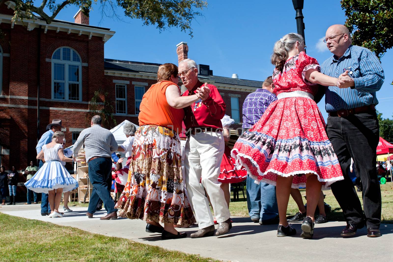 Lawrenceville, GA, USA - October 12, 2013:  Senior citizens square dance outdoors at the Old Fashioned Picnic and Bluegrass Festival.  The event was free to the public.  