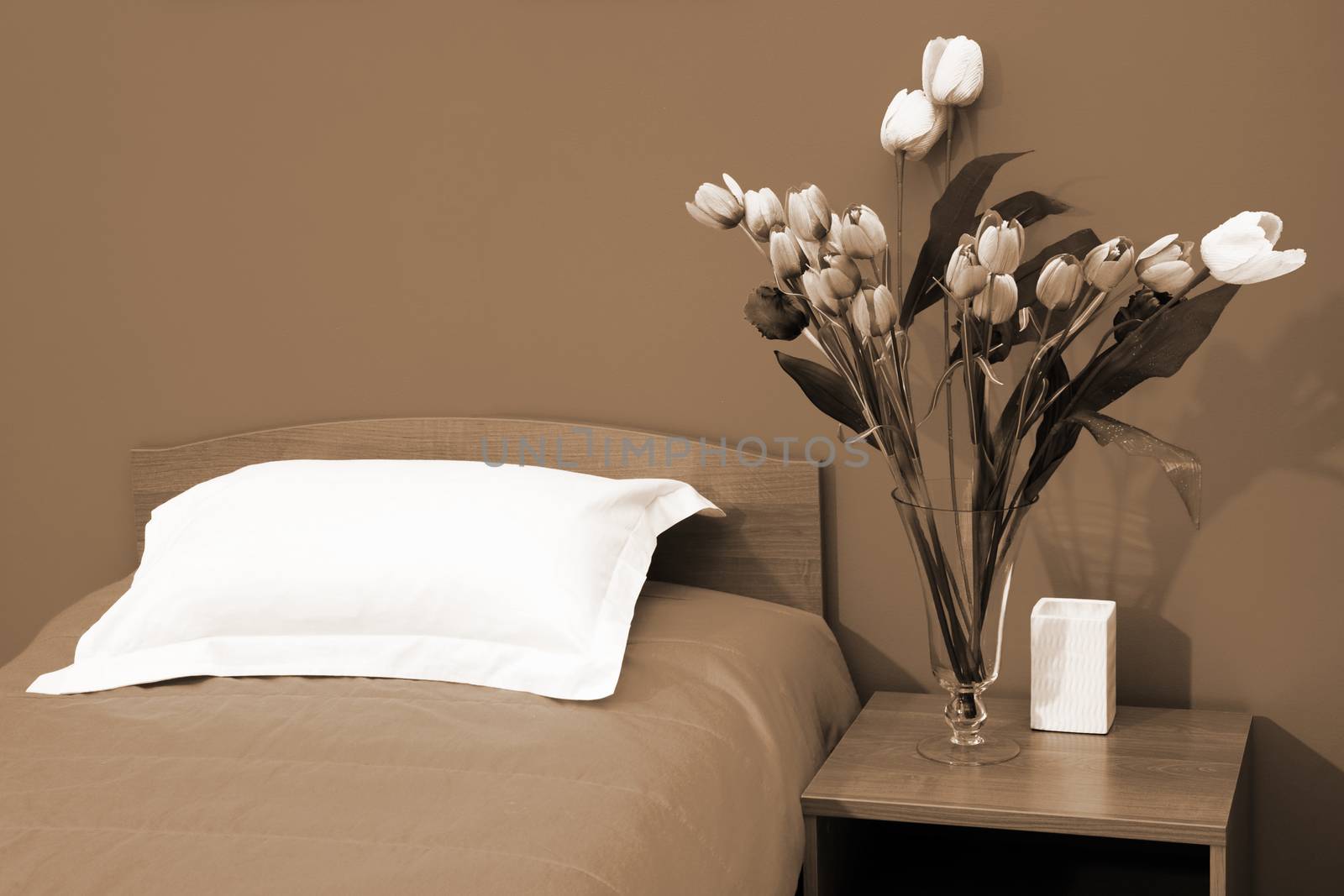 Beautiful tulips at a bed with an coverlet