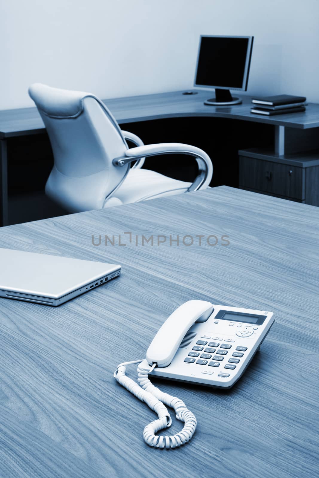 Phone and laptop on a table at modern office