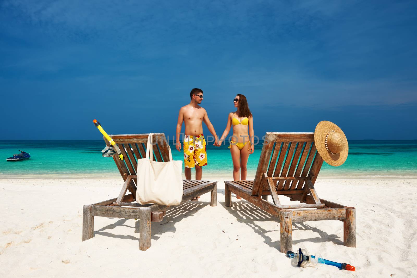 Couple in yellow on a beach at Maldives by haveseen