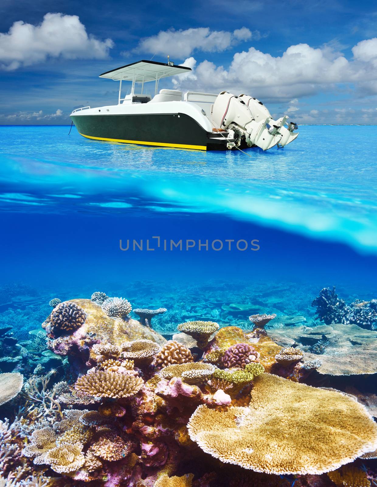 Beach and motor boat with coral reef underwater view by haveseen