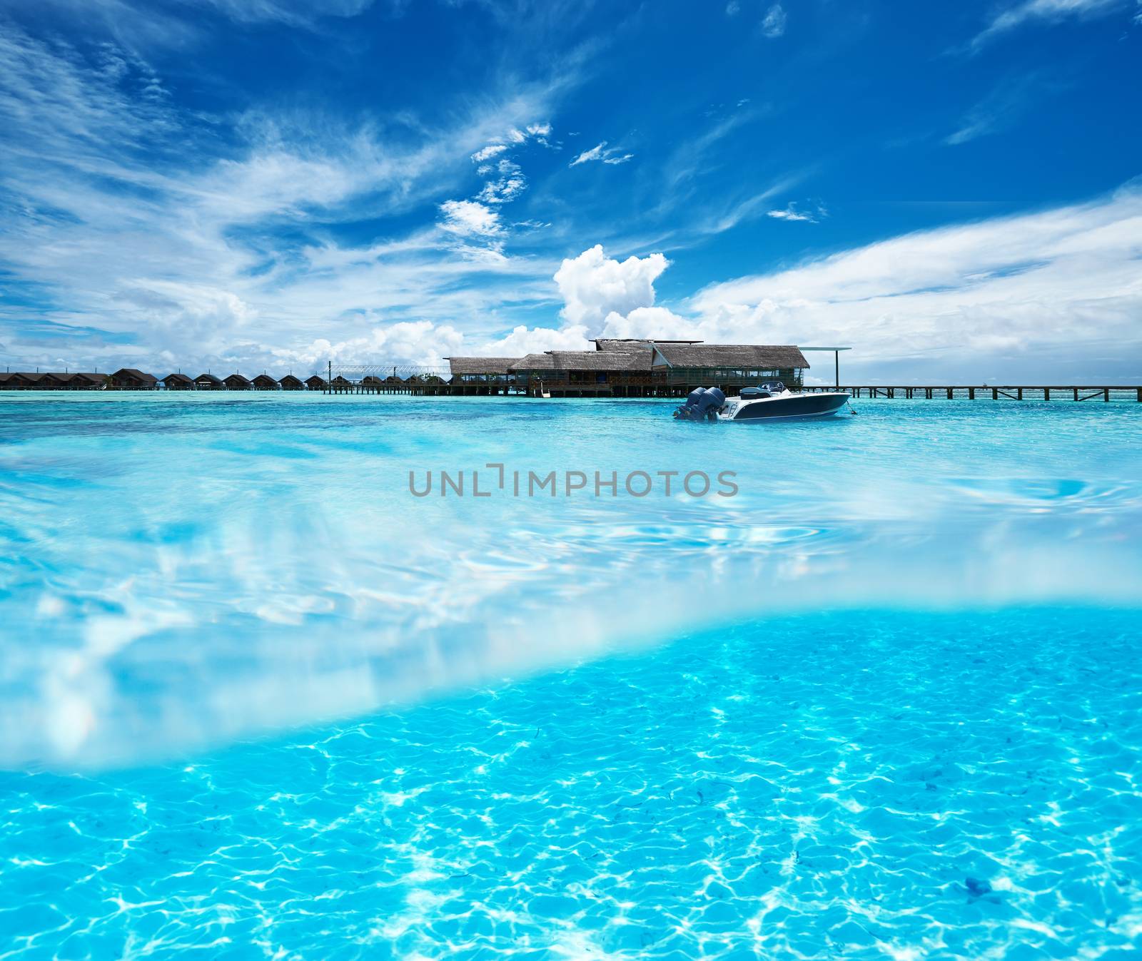 Beautiful beach with white sand bottom underwater and above water split view