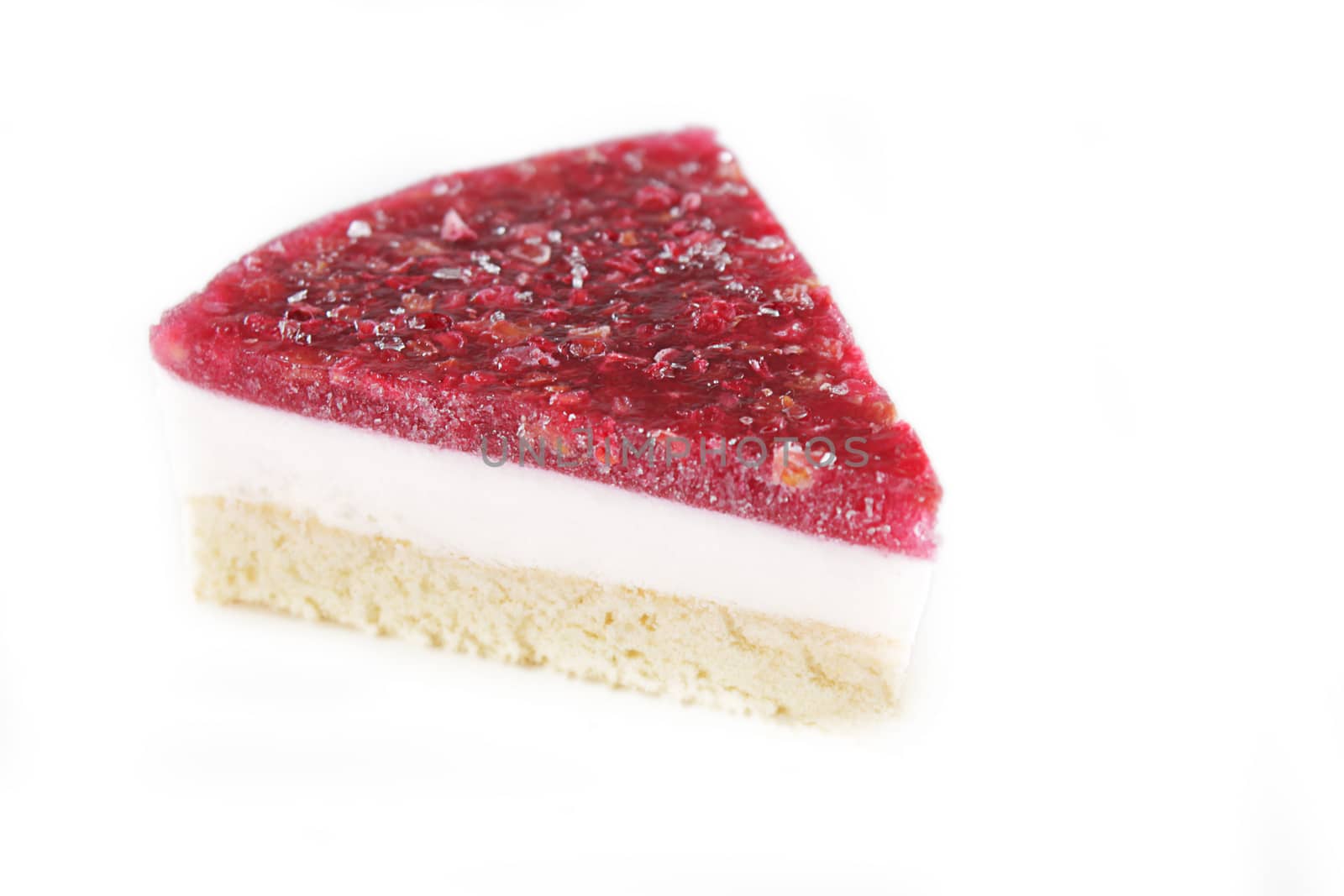 Piece of cheesecake with raspberry over white