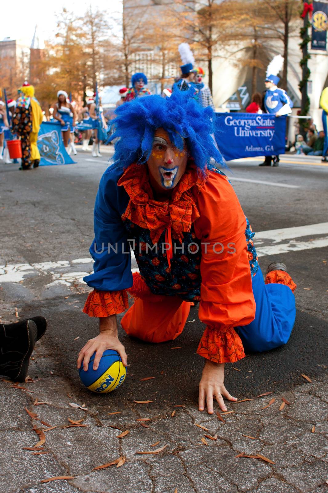 Atlanta, GA, USA - December 1, 2012:  A clown acts goofy as he performs for thousands of spectators attending the annual Atlanta Christmas parade in downtown Atlanta.