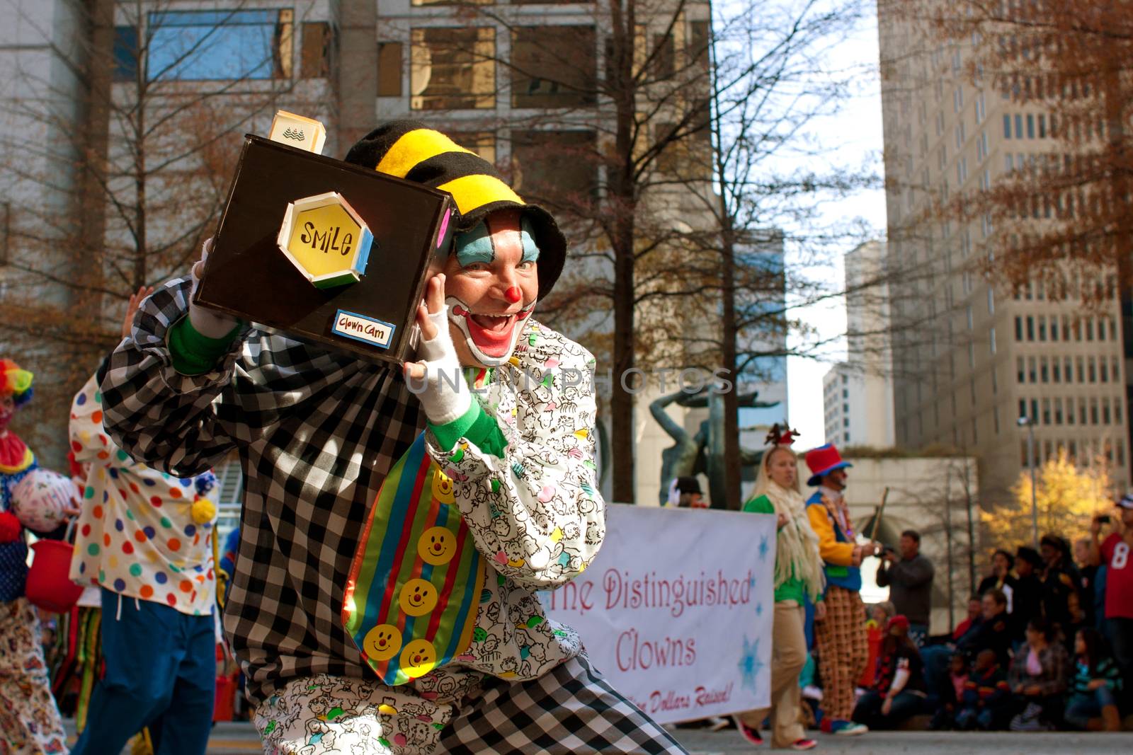 Atlanta, GA, USA - December 1, 2012:  A clown poses with his "smile cam," as he performs for thousands of spectators attending the annual Atlanta Christmas parade in downtown Atlanta.