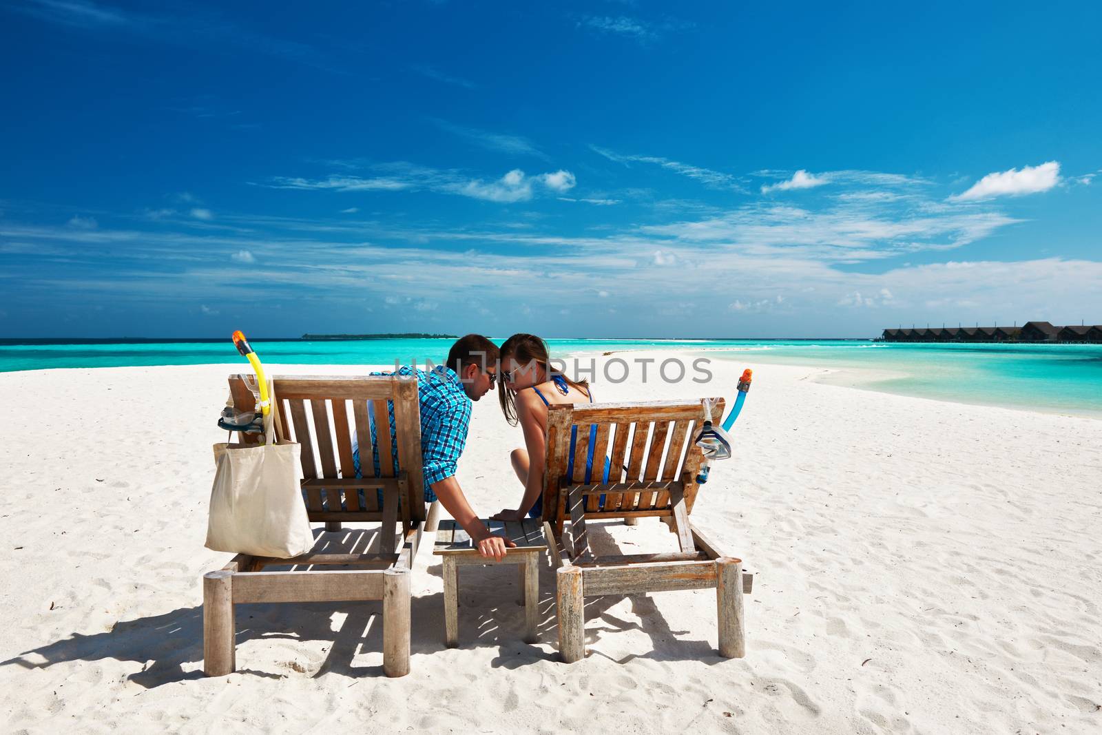 Couple relax on a beach at Maldives by haveseen