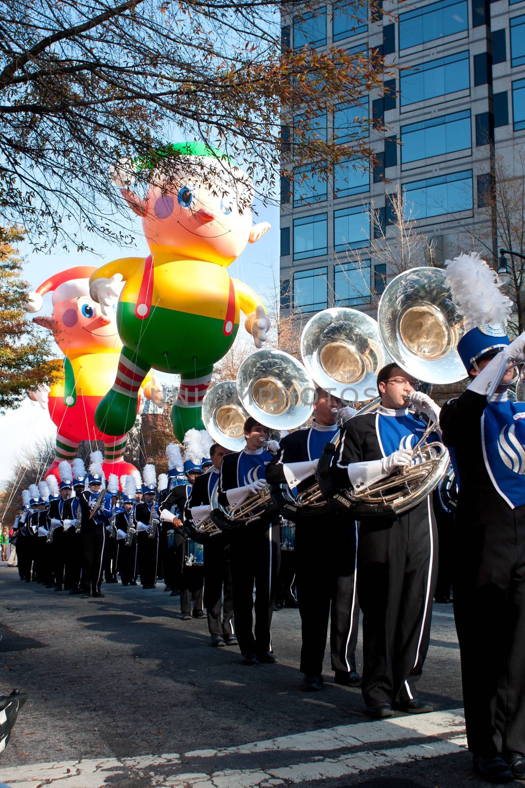 Atlanta, GA, USA - December 1, 2012:  The Georgia State University band plays as floats hover in the background, at the start of the annual Atlanta Christmas parade in downtown Atlanta.