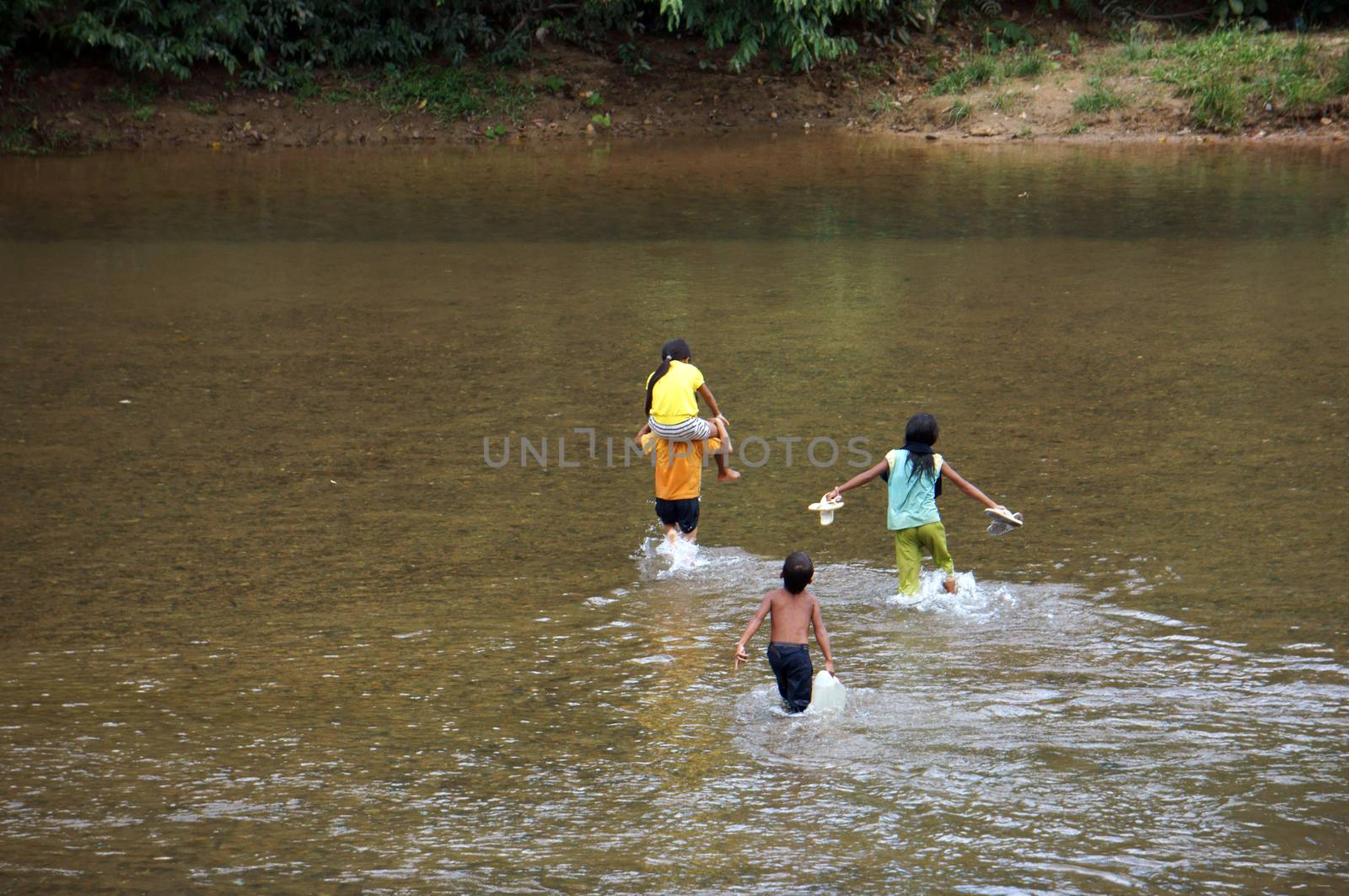 KHANH HOA, VIET NAM- FEBRUARY 5: Chidren  across a stream, this is warning about  children's drowning  situation at countryside, Khanh Hoa, February 5, 2013 