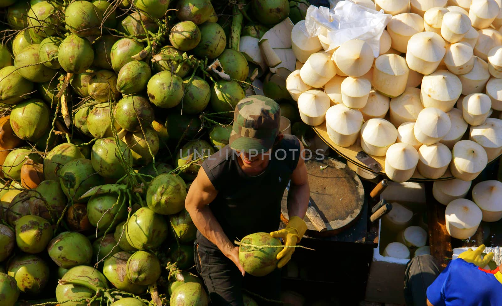 DA LAT, VIET NAM- FEBRUARY 8: People sell and buy coconut at farmers market in  Dalat, VietNam- February 8, 2013
