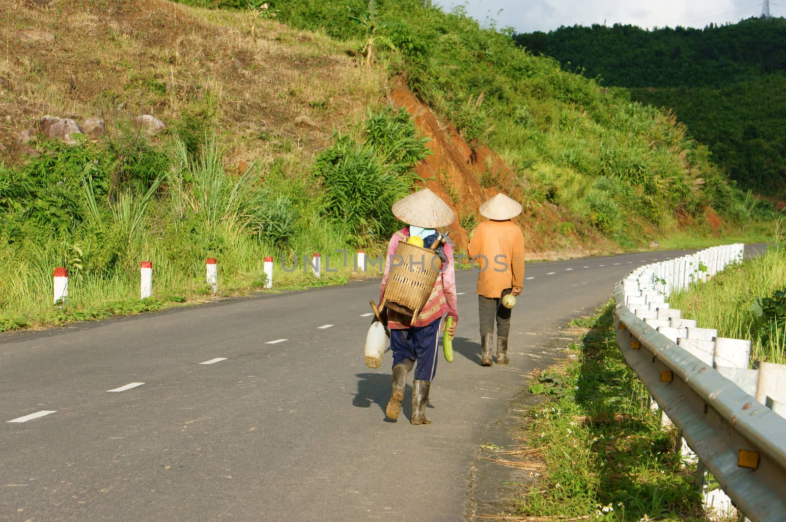  DAK LAK, VIET NAM- SEPTEMBER 4: People walking on countryside road to coming home after finish work in Viet Nam country side on September 4, 2012      