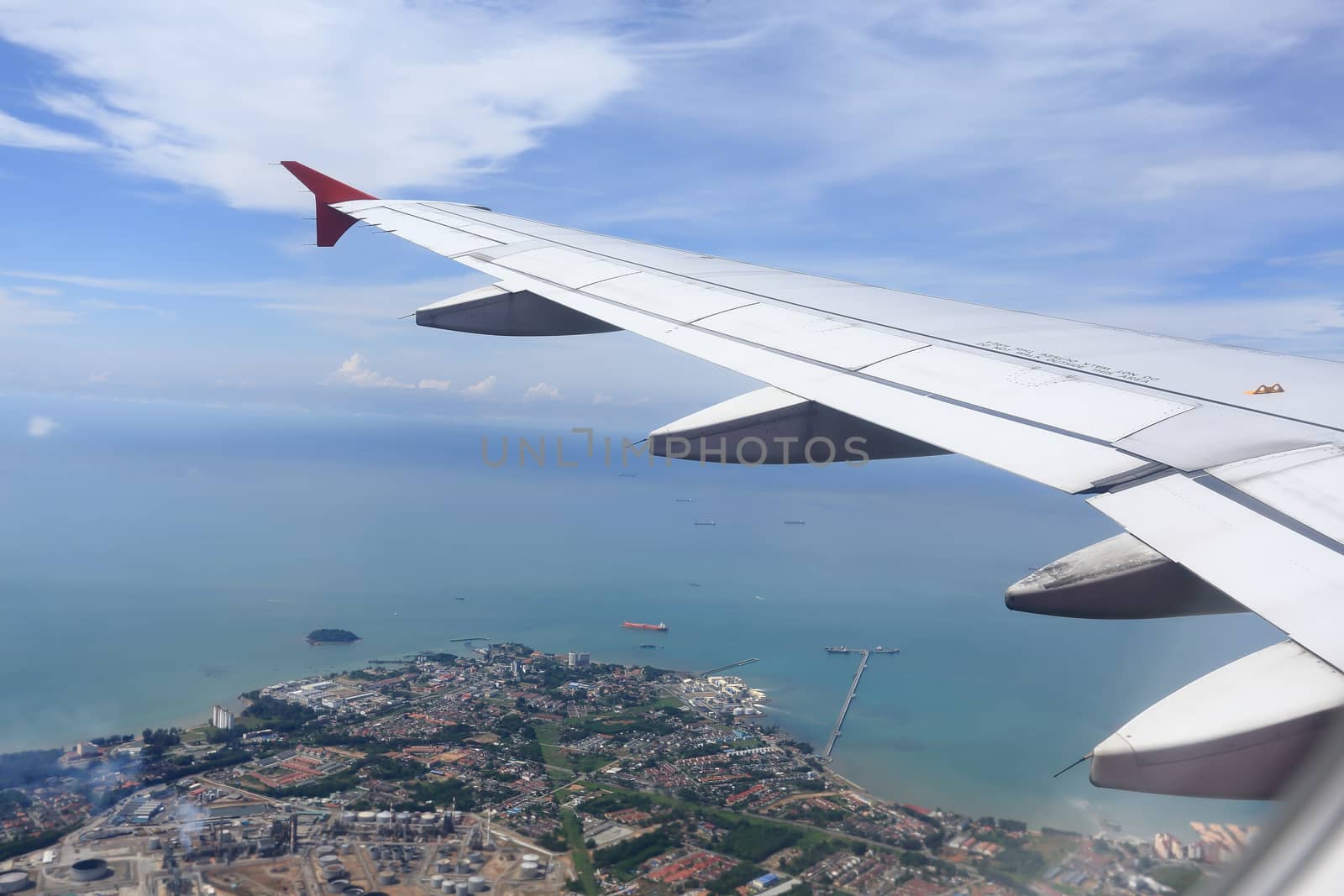 Wing of an airplane flying above the clouds. by rufous