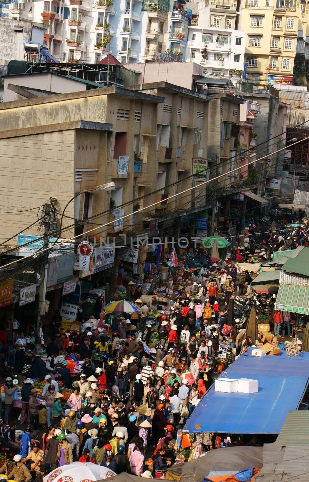 DA LAT, VIET NAM- FEB 8: Crowded, busy scene 's market with crowd of people go to markets to buy goods repair for Tet (Lunar New Year) in Da Lat, Viet Nam on February 8, 2013