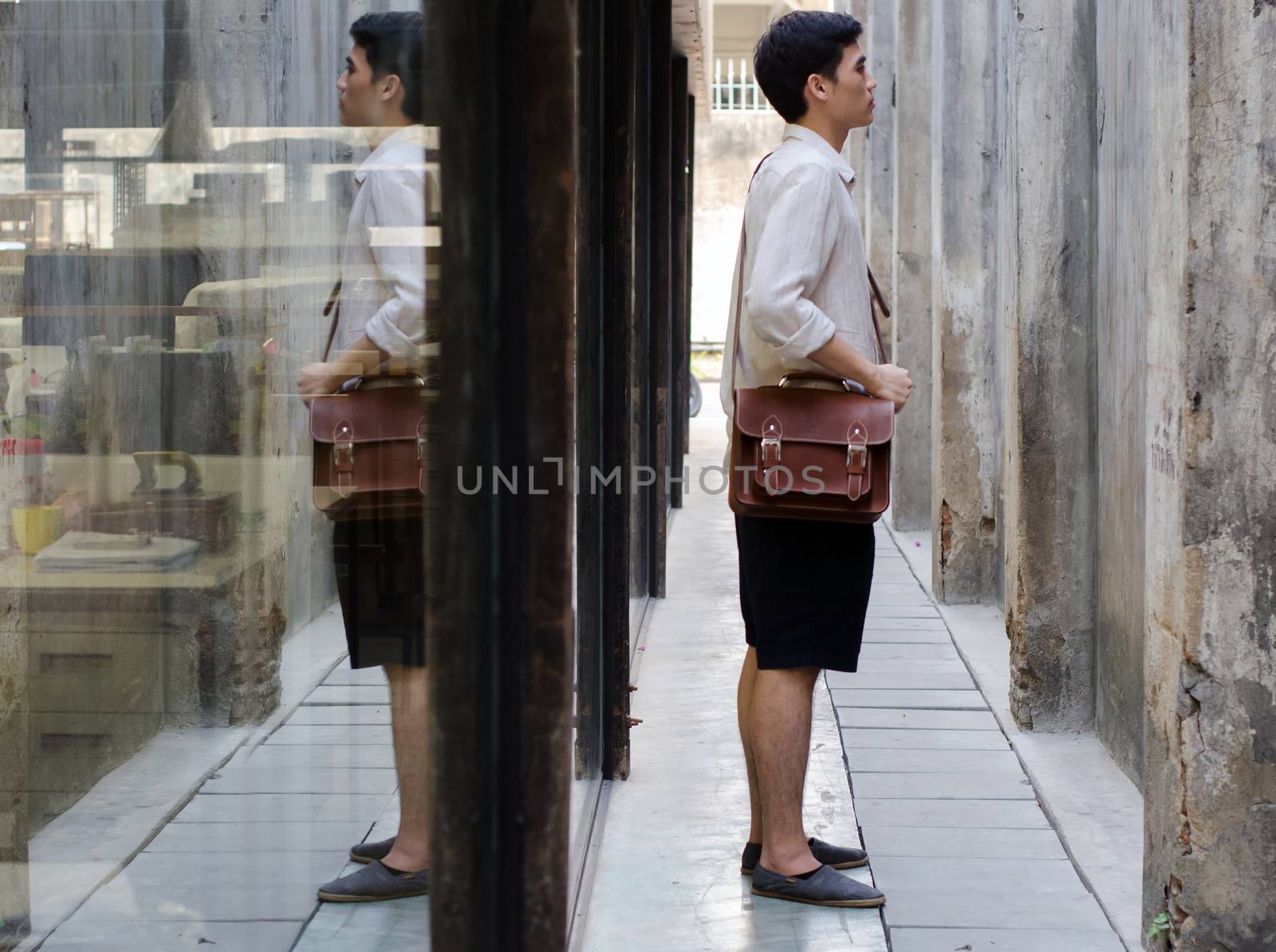 Attractive man with leather bag by siraanamwong